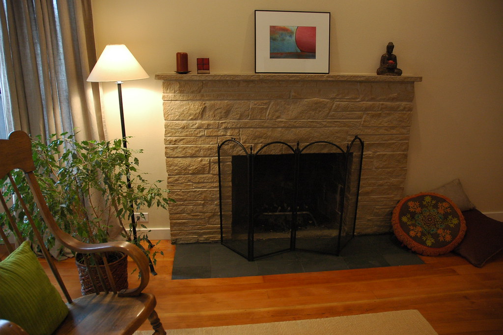Zen style - painted stone fireplace makeover with flat black slate inlayed hearth, pillows, Buddha candleholder, origina